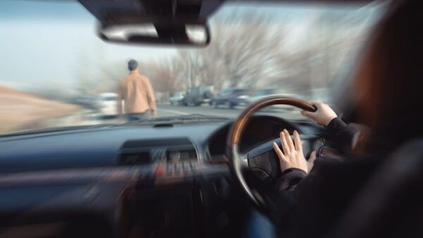 View from inside a car approaching a pedestrian in the roadway in San Jose, illustrating the moment before impact in a government vehicle accident claim